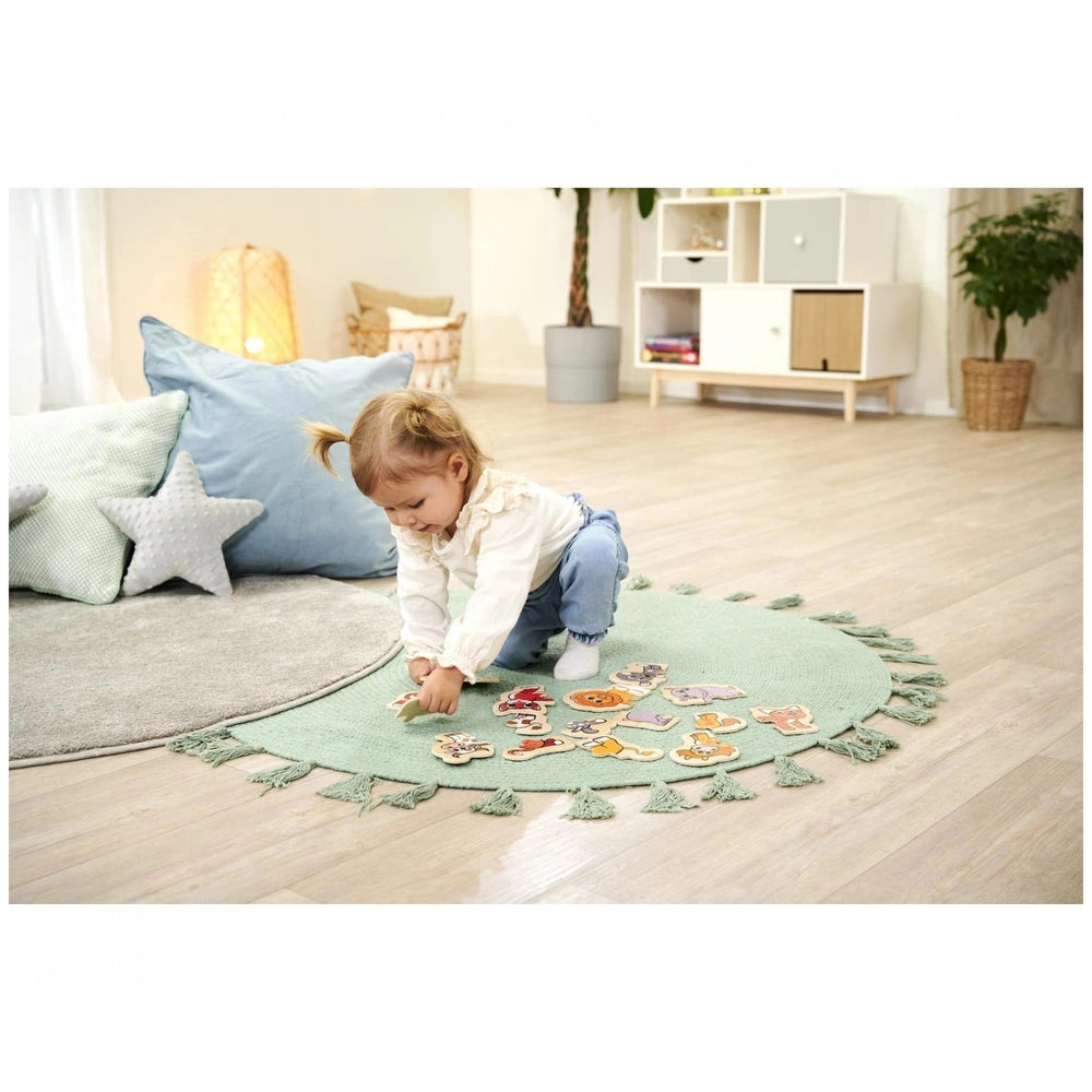 Eichhorn wooden animal puzzle with a child on a green play mat, featuring minimalistic decor and a serene play environment.