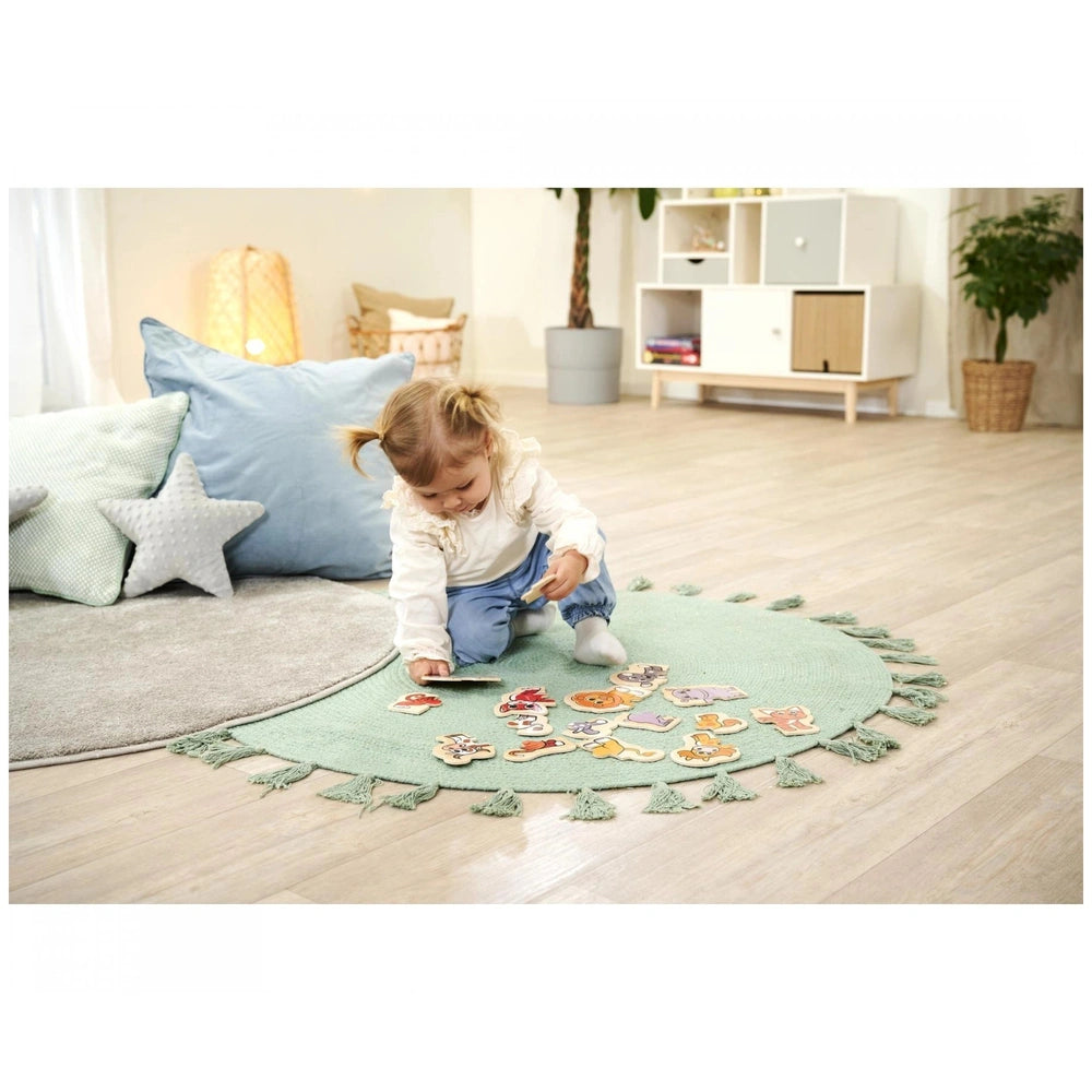 Eichhorn wooden animal puzzle with 16 colorful pieces, engaging a young child in a bright, cheerful room setting.