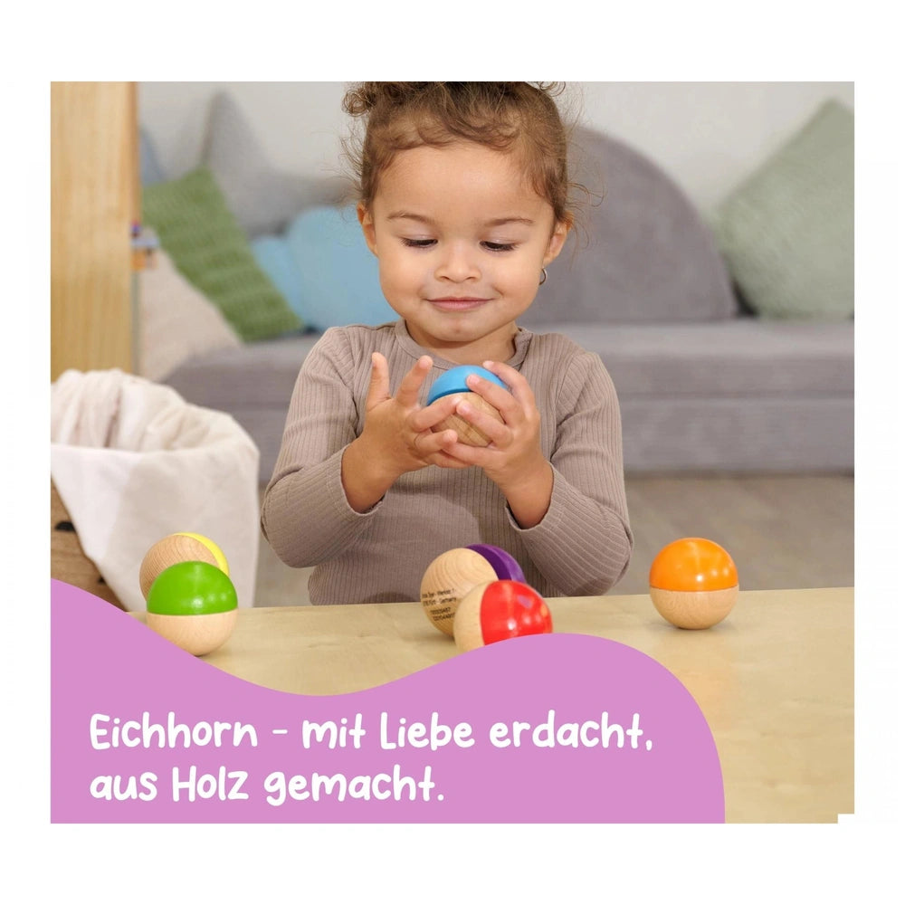 Eichhorn Wooden Music Balls set, colorful balls for babies, showcased with a happy child engaged in play.