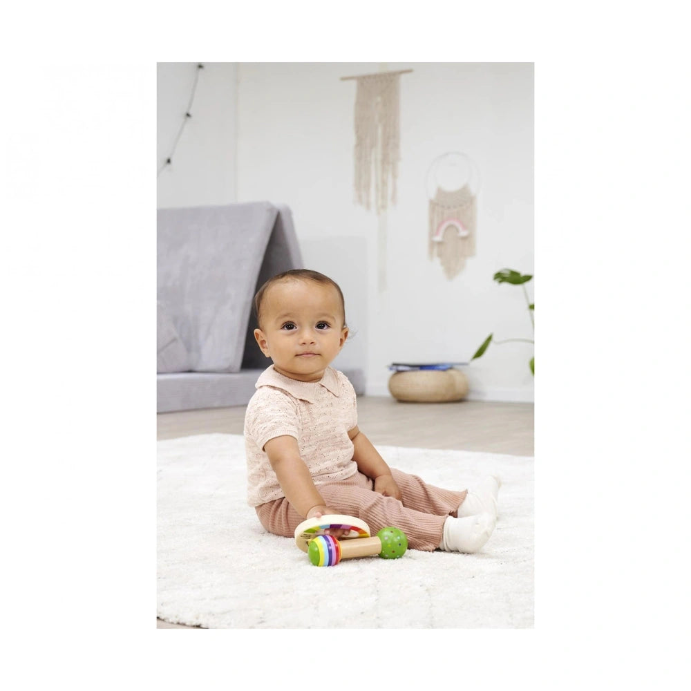 Eichhorn wooden music set being enjoyed by a young child on a shaggy rug in a bright, playful indoor setting.