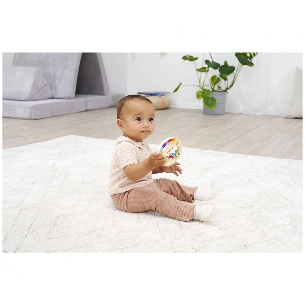 Eichhorn Wooden Music Set featuring a toddler playing with a colorful musical toy in a minimalist, bright room.