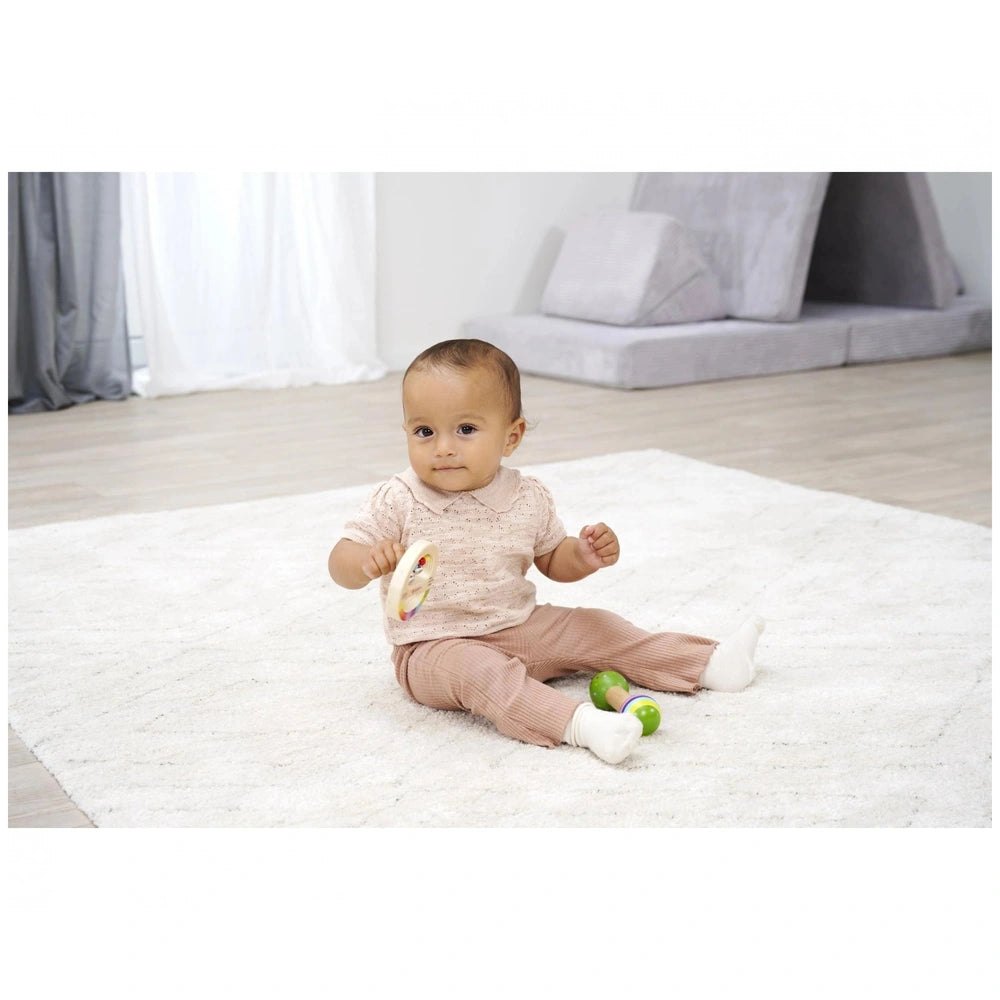 Eichhorn Wooden Music Set with a child playing on a white rug, surrounded by a cozy indoor living space.