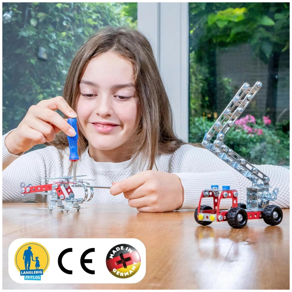 Eitech Rubin Rocket Racer blue construction set toy displayed on a wooden tabletop with a young girl playing.