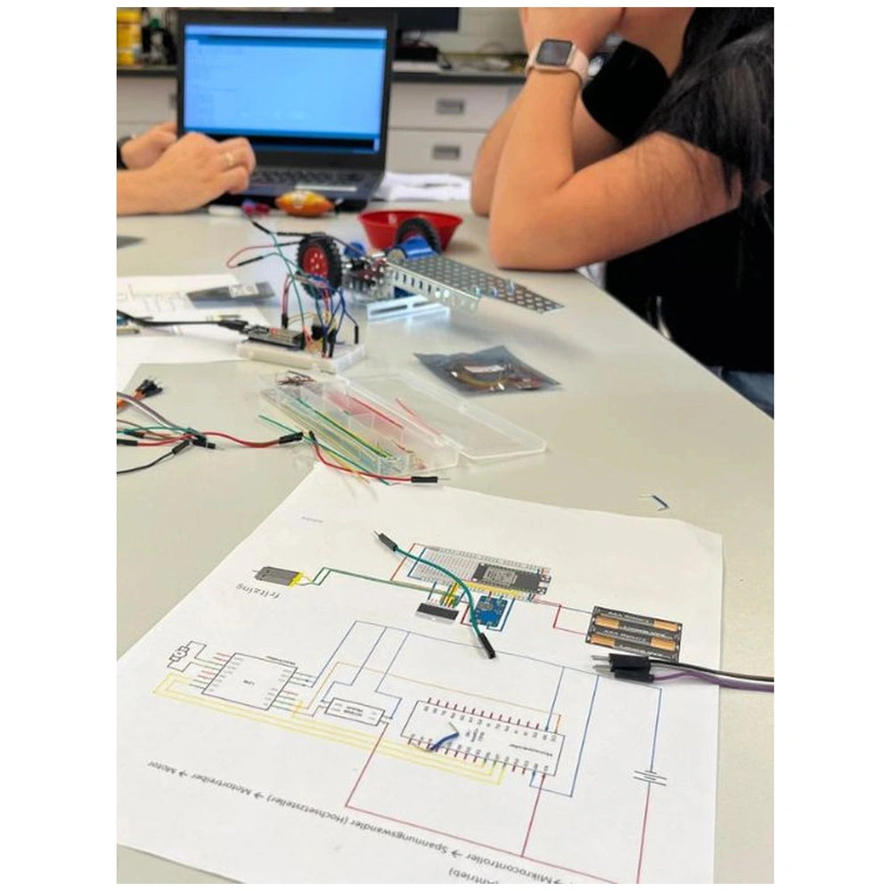 Eitech Speed Racer construction set features a yellow circuit board, black wires, and metal components on a plastic tabletop.