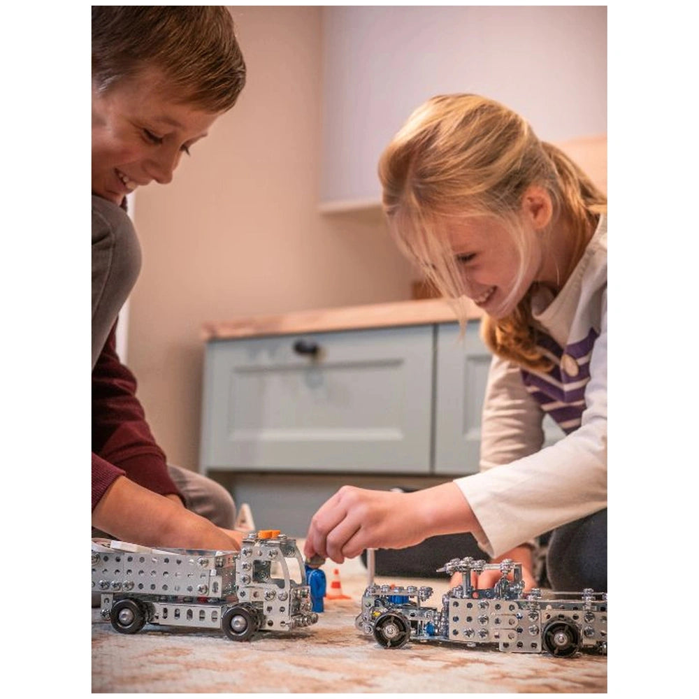 Eitech Speed Racer construction set features a silver toy truck on a light-colored carpet with two people engaged nearby.
