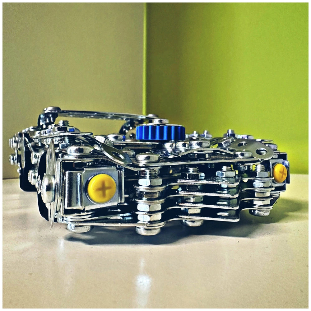 Eitech Speed Racer construction set features a glossy silver metal surface, yellow button, blue component, and gear system.