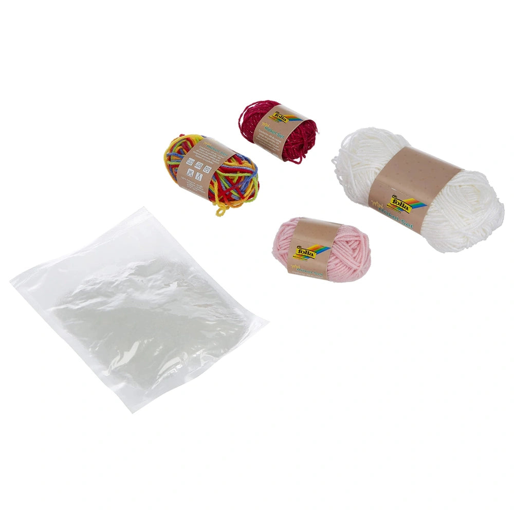 Folia Mini Crochet Kit featuring colorful yarn balls in red, yellow, pink, and white, packaged in clear plastic wrap and brow
