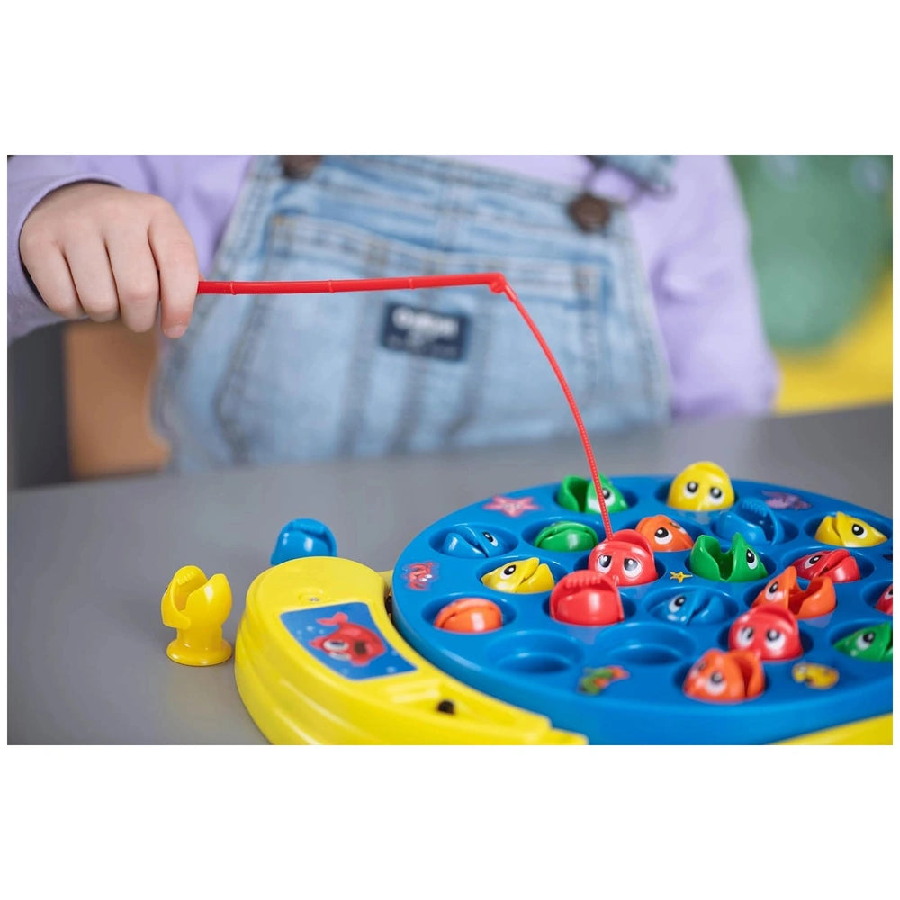 Goliath Let's Go Fishing game features colorful plastic toys in yellow, blue, orange, and green with a red rubber band.