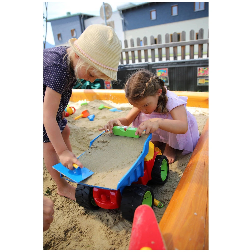 Gowi Design Bricklaying Set features two girls in colorful dresses playing with bright plastic sand toys in a sandy sandbox.