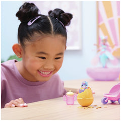 Hatchimals Alive Hatch N’ Stroll Playset with stroller and mini figures is being explored by a smiling girl in a purple top.