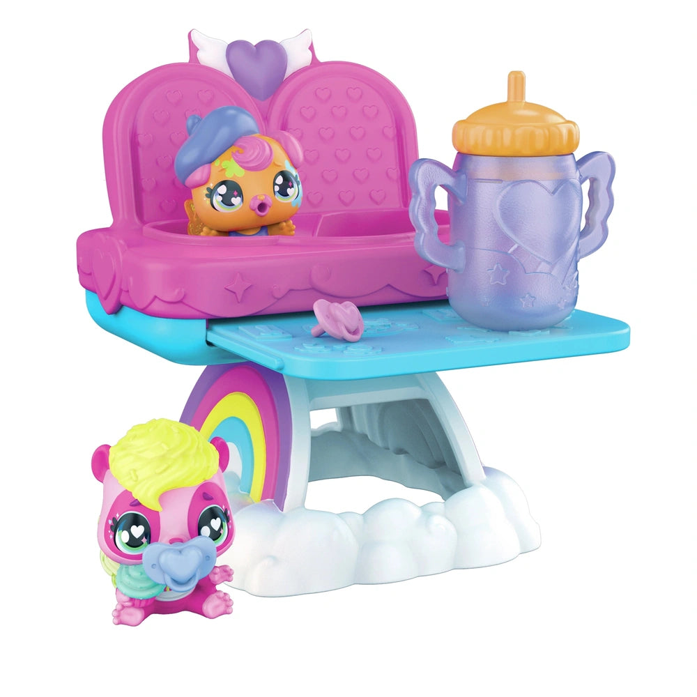 Hatchimals Alive playset features a pink heart-shaped chair, blue table, and a colorful toy character with a hat and bottle.