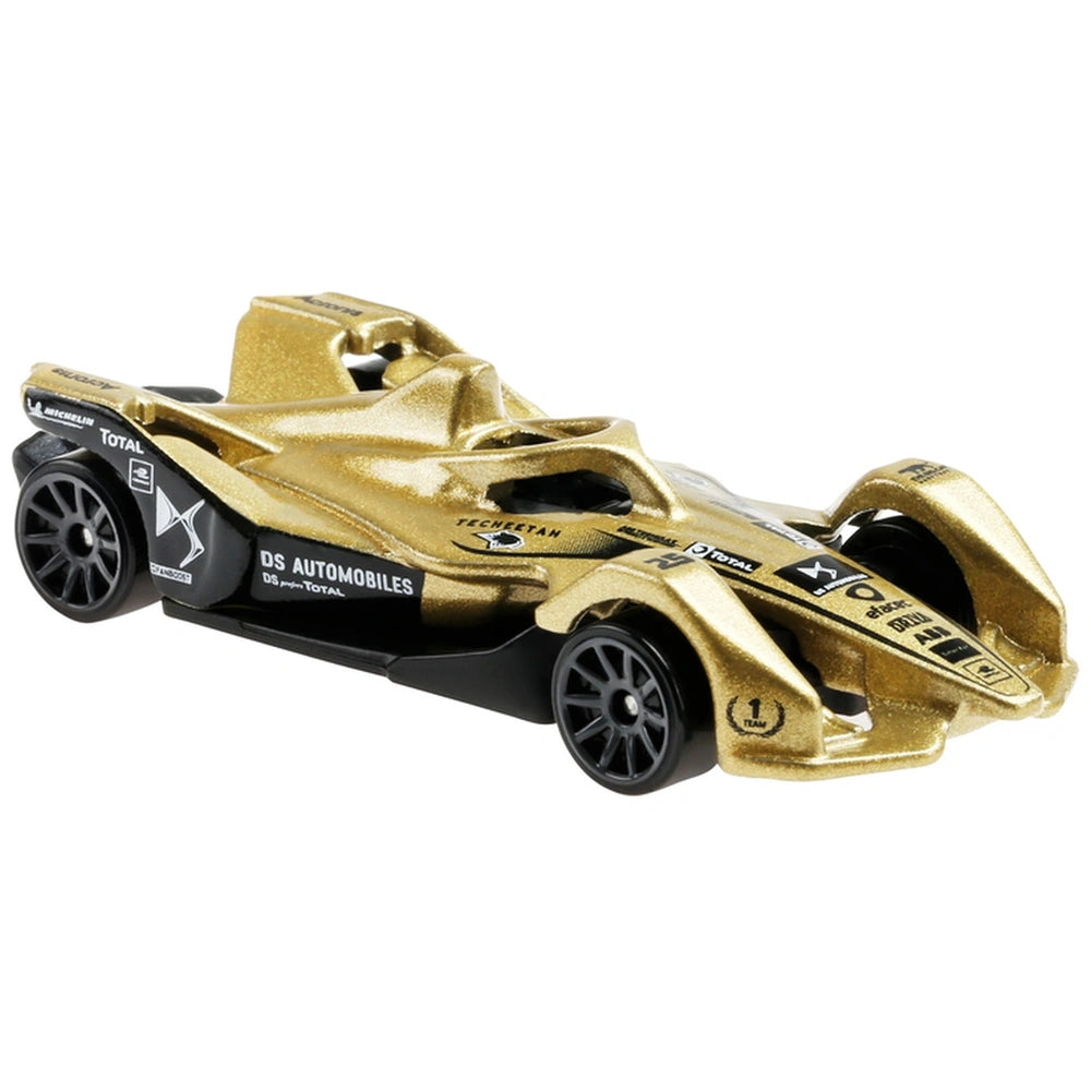 Gold die-cast Hot Wheels car with black wheels, featuring a glossy finish and detailed components like a spoiler and side mir