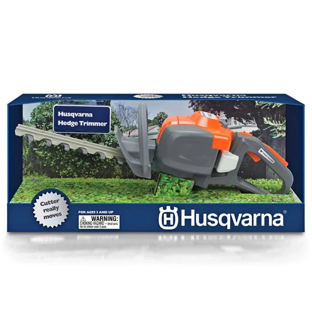 Husqvarna toy hedge trimmer in blue cardboard packaging with a transparent window displaying a grey and orange trimmer and gr