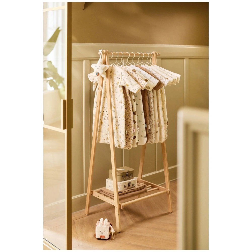 Jollein Activity Cube Animal Friends displayed on a brown wooden clothing rack with white patterned fabric items in a lifesty