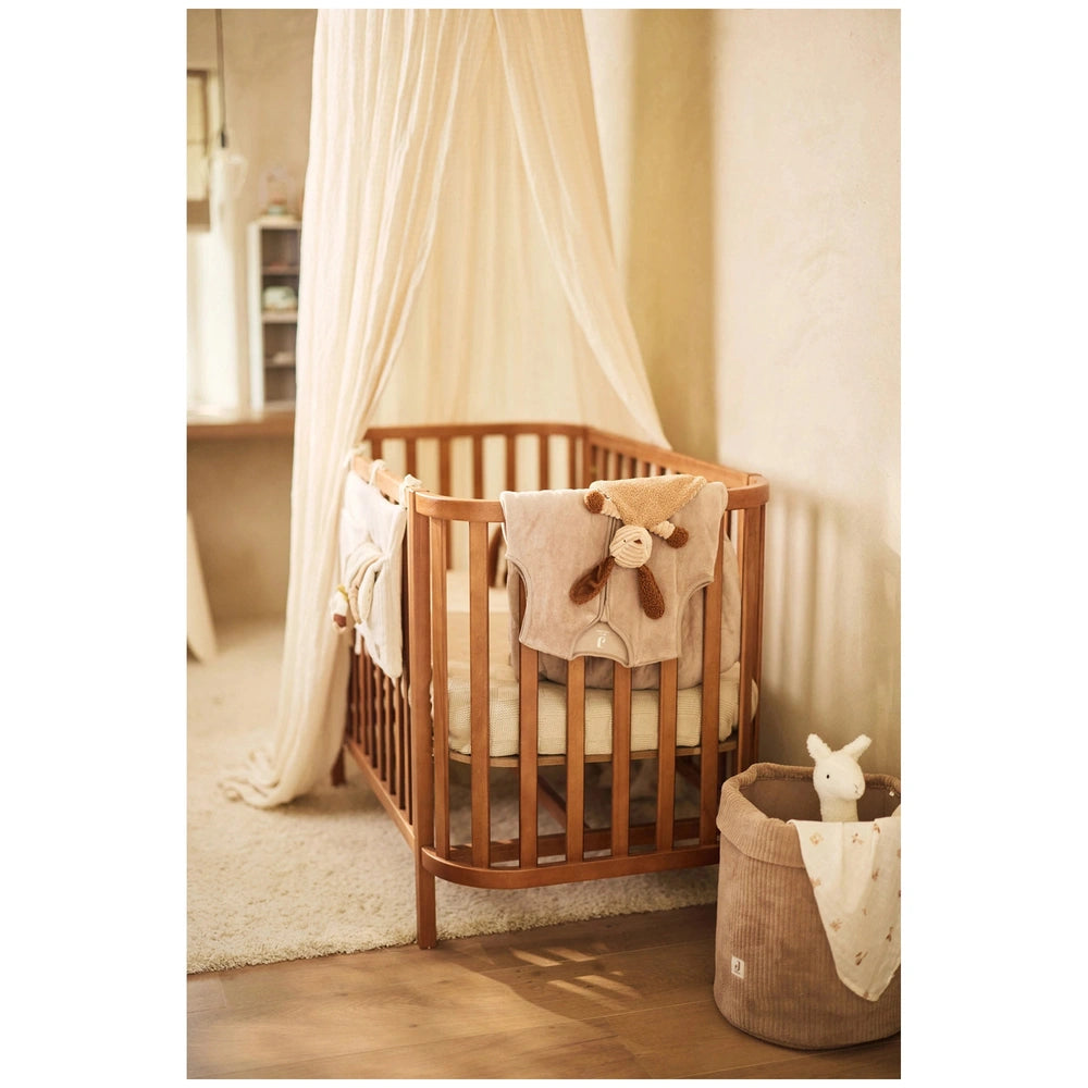 Jollein pacifier cloth featuring animal friends in a serene nursery with white decor and a cozy wooden crib.