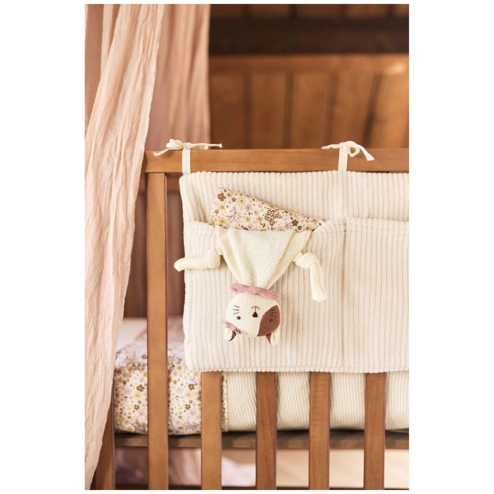 Jollein pacifier cloth Jill displayed on a wooden crib railing, featuring white fabric with floral and colorful trims.