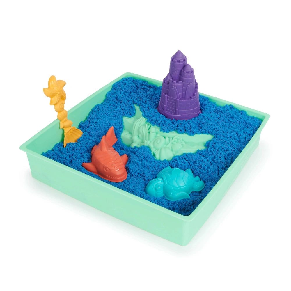 Kinetic Sand Sandbox Set features a blue plastic tray filled with sand-like texture and colorful plastic toys including a cas
