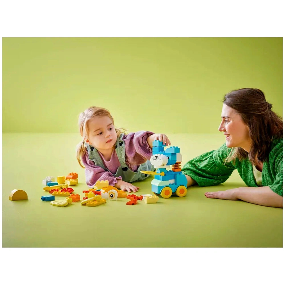 LEGO - 3in1 Animals on Wheels construction set is being played with by a child in a cozy indoor setting with a smiling woman.