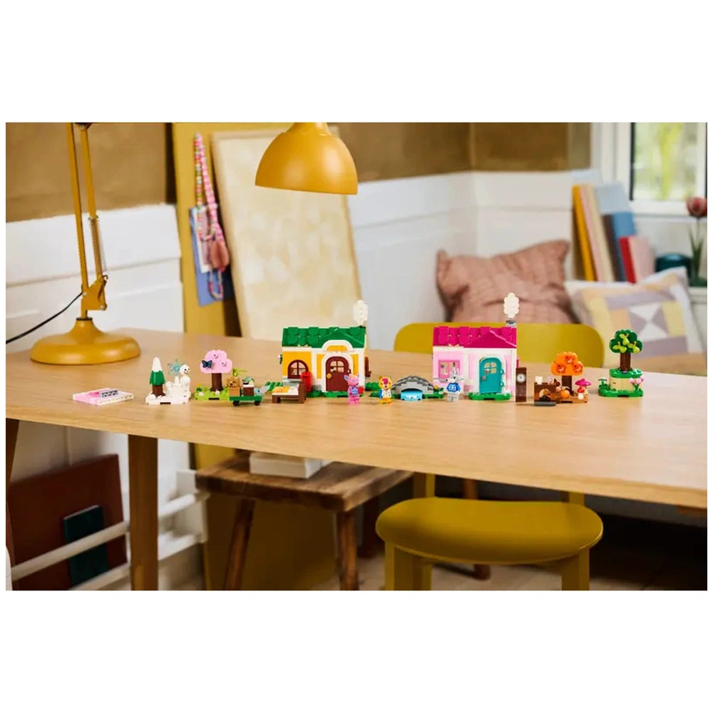 Colorful LEGO construction set featuring two houses inspired by Animal Crossing, playful figures, and seasonal accessories on a wooden table.