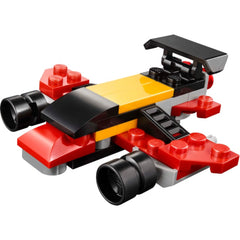 Vibrant LEGO Creator Mini Convertible Monster Truck featuring red, yellow, and black pieces. The design showcases large wheels, a smooth body, and an aerodynamic spoiler, emphasizing creativity and fun for young builders.