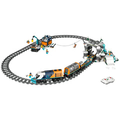 LEGO® Explorers' Arctic Polar Express Train set features a colorful train on curved tracks, surrounded by snowy scenery, a mountain tunnel, and playful minifigures engaging in activities.