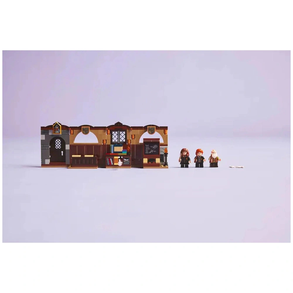 LEGO Hogwarts Castle Charms Class set featuring a classroom, desks, and three mini-figures of Hermione, Ron, and a wizard.