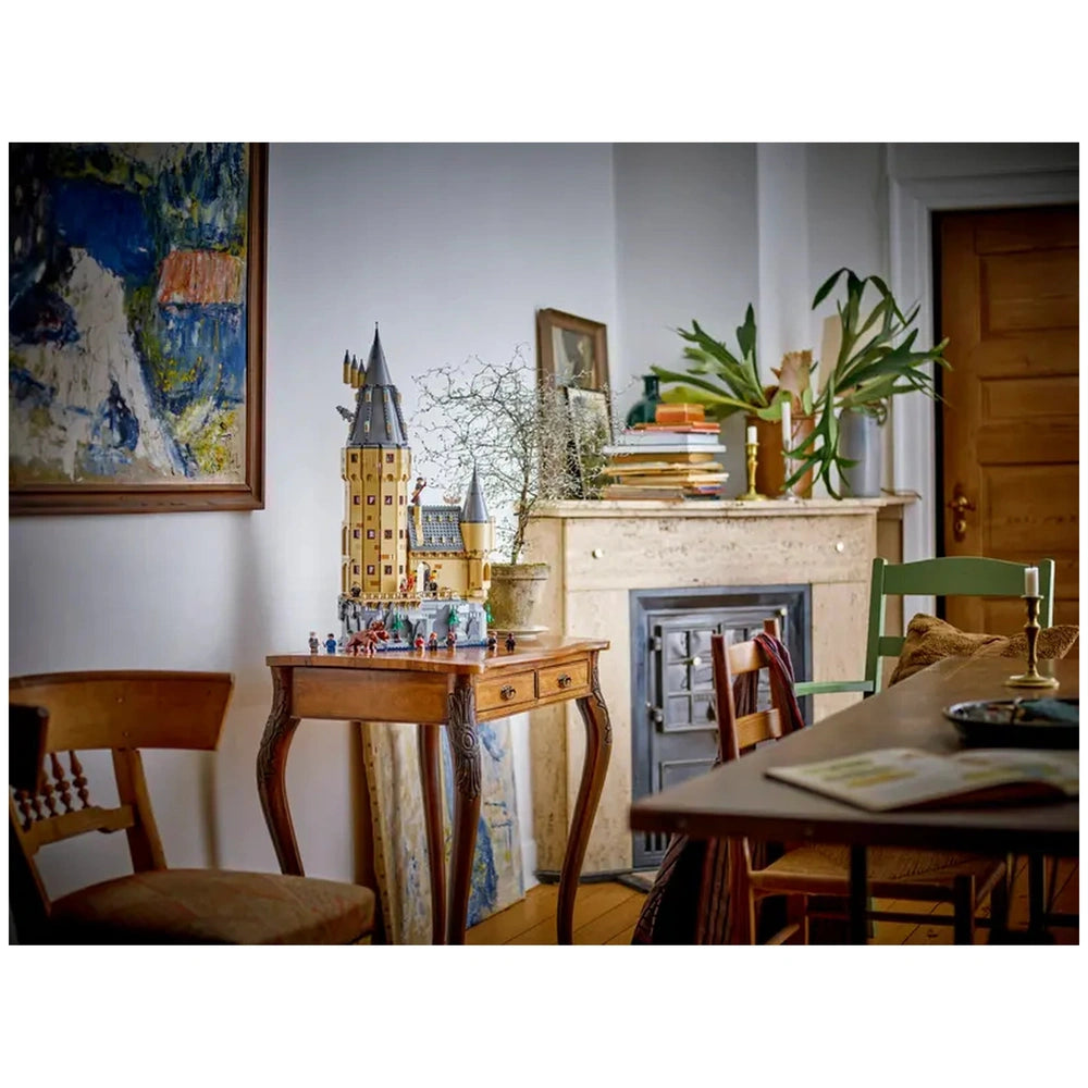 LEGO Harry Potter Hogwarts Castle set displayed on a wooden table, with intricate details and minifigures, surrounded by a cozy room decor.