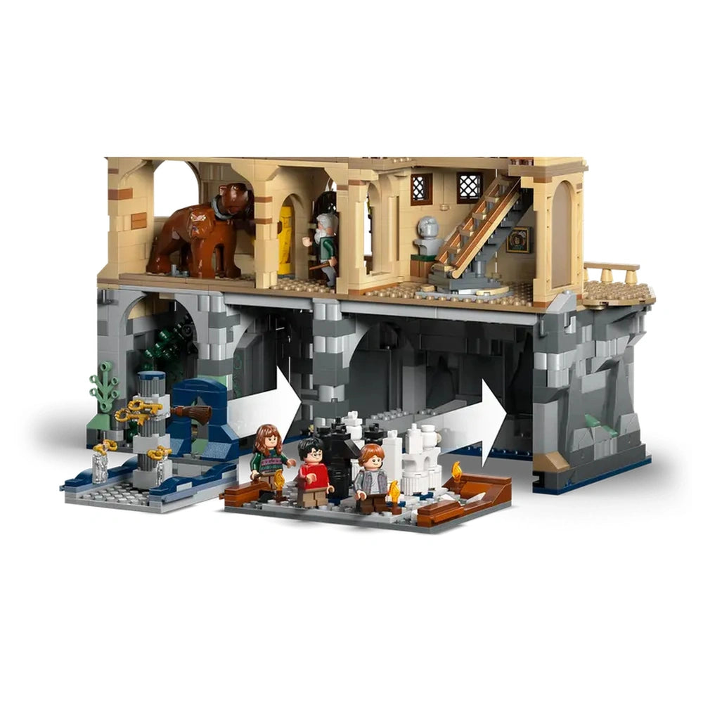 LEGO Harry Potter Hogwarts Castle set featuring detailed rooms, including Fluffy's lair, the Grand Staircase, and minifigures of Harry, Hermione, and Ron sitting on benches.