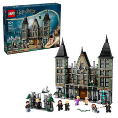 LEGO Harry Potter Malfoy Manor set featuring a detailed model of the manor with gray and green bricks, two spires, and seven characters including Draco Malfoy and Harry Potter. The scene also includes a replica entrance gate, a well-lit front door, and ghostly figure accessories, creating an enchanting depiction of the Wizarding World.
