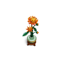 LEGO® Icons Chrysanthemum construction set featuring vibrant orange flowers in full bloom with green leaves, placed in a pastel green pot with a golden band.