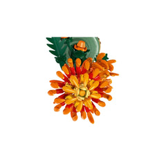 Colorful LEGO® Icons Chrysanthemum construction set featuring vibrant orange and yellow petals with posable leaves, set in a green flowerpot.