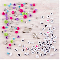 MAKE IT REAL Block ‘N’ Rock Bracelets featuring colorful beads and metal components scattered on a light surface.