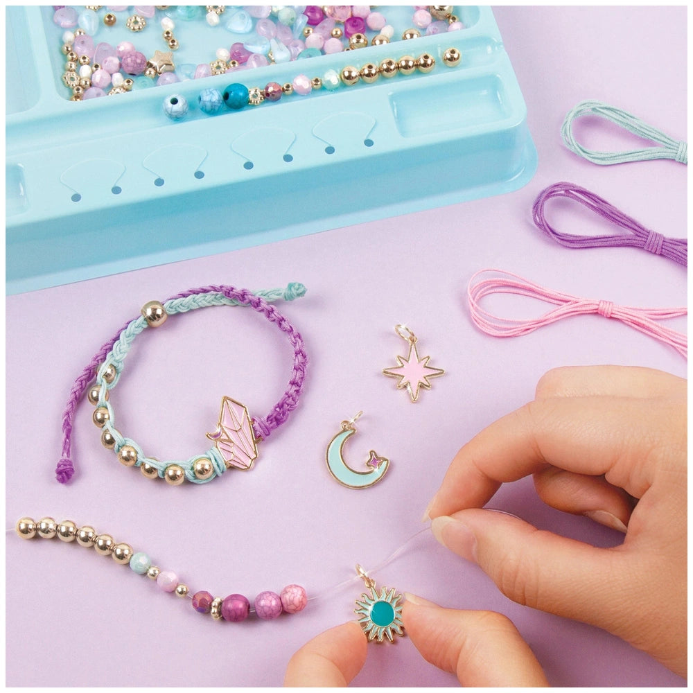 Celestial Stones Bracelets featuring gold, silver, and colorful beads in a blue plastic container with a clear lid.