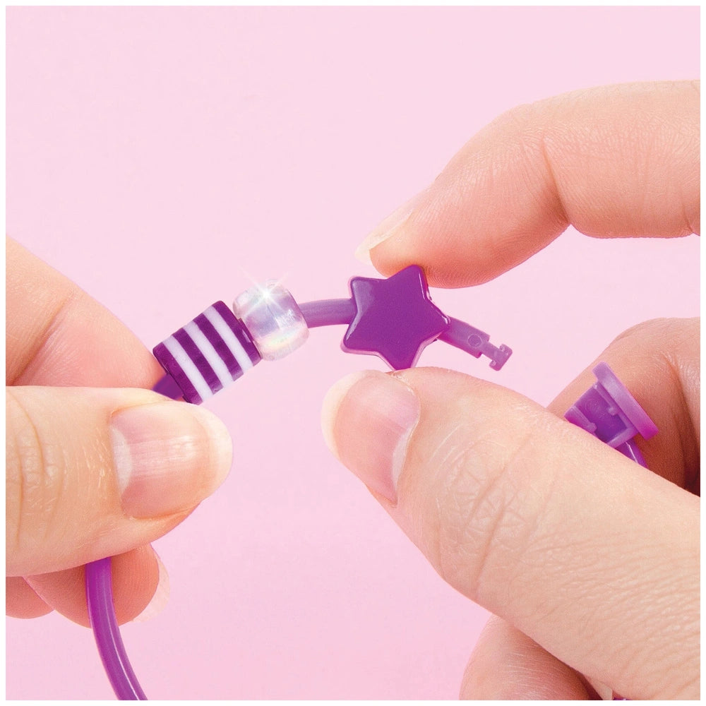 DIY Fashion Beaded Bangle Bracelets held by two hands, featuring a purple star-shaped key-like end.