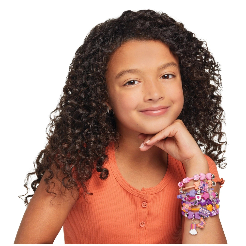 DIY Fashion Beaded Bangle Bracelets worn by a smiling girl with curly dark hair in an orange top, centered in the image.
