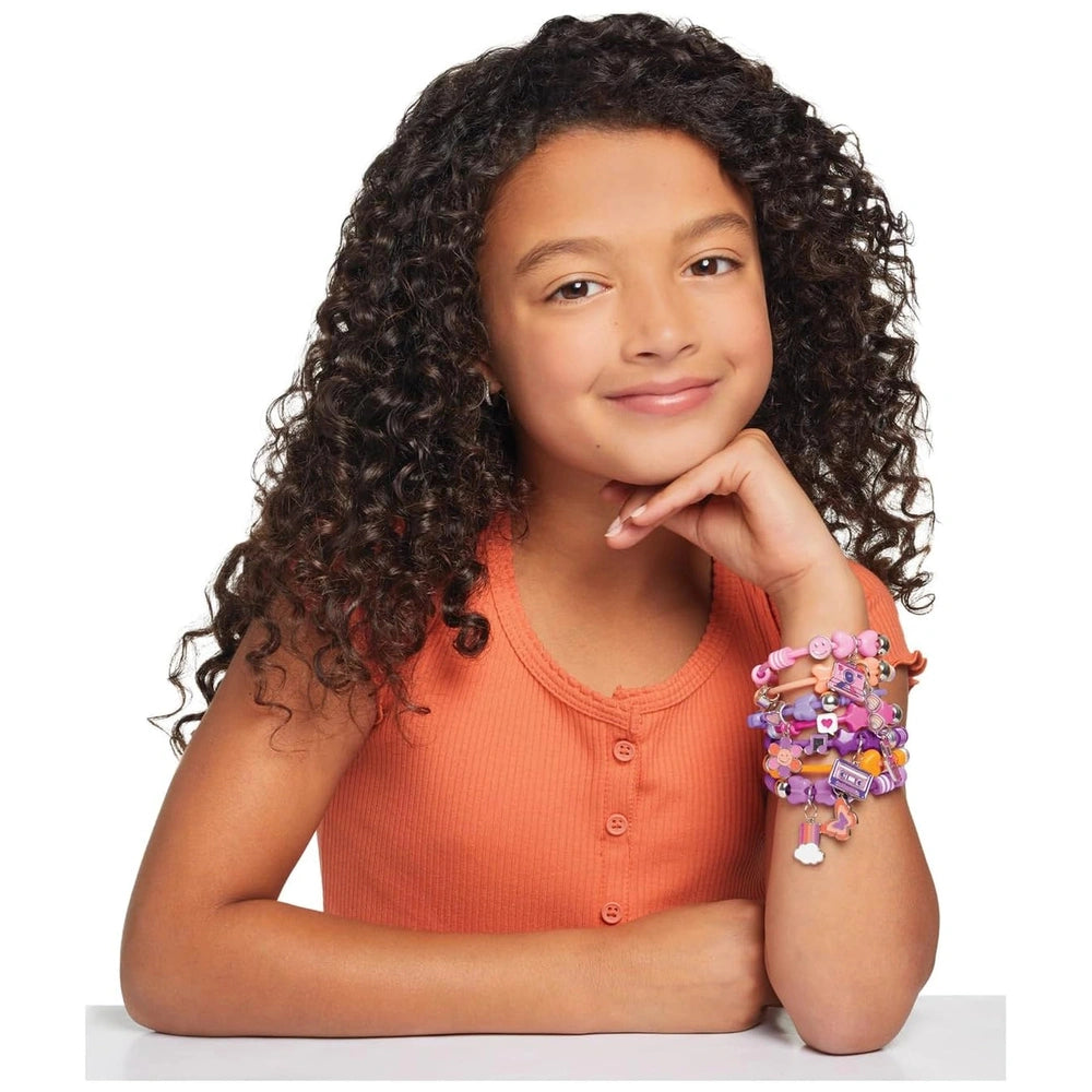 DIY Fashion Bracelet Set featuring a child with curly dark brown hair wearing an orange top and a colorful multi-strand brace