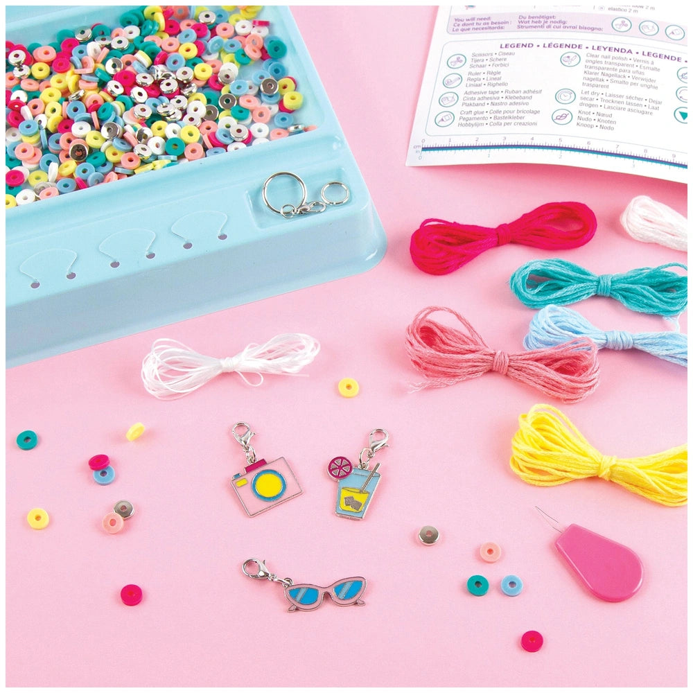 MAKE IT REAL Summer Vibes Heishi Bead Set featuring vibrant ribbons and yarns in a blue plastic container, arranged centrally