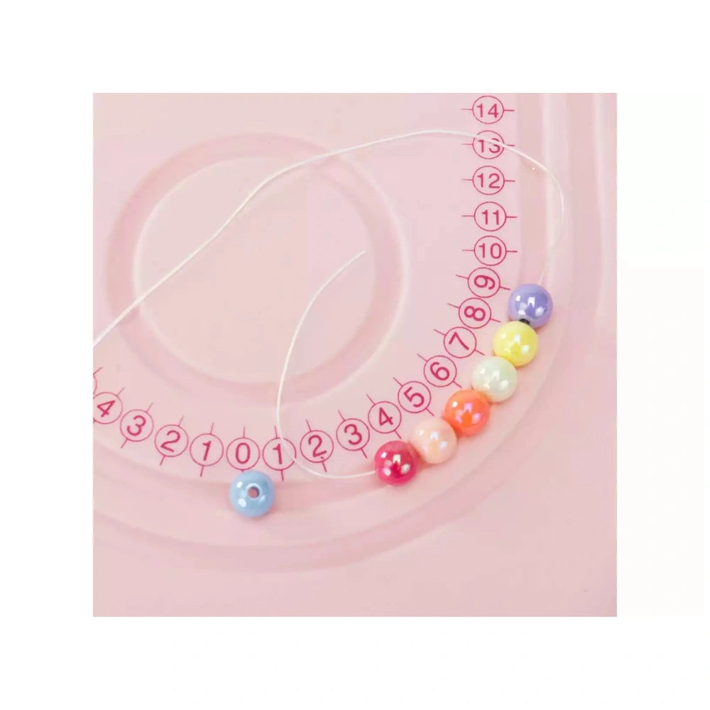 Jewel Design 600 Precious Beads featuring 14 translucent beads in blue, pink, yellow, green, orange, and white on a pink surf