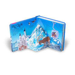 NUINUI Montagna Sorprendenti Pop Up book with glossy cover, blue background, and colorful illustrations, open to a two-page s