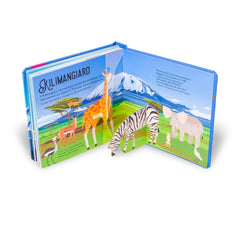 NUINUI Montagna Sorprendenti Pop Up book features a giraffe, zebra, and elephant against a blue background with mountain illu