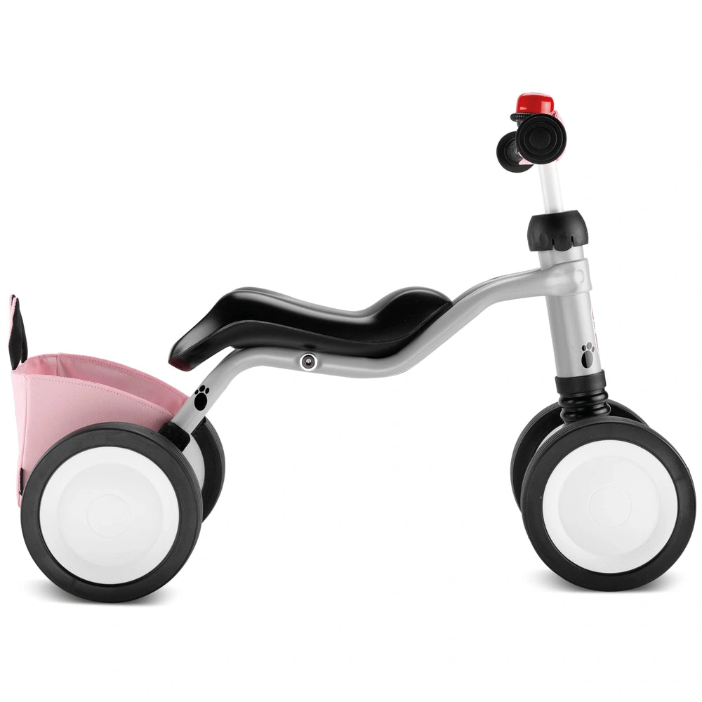 Puky Wutsch Bundle pink and gray metal quadricycle features a black seat, silver handlebar, and pink basket.