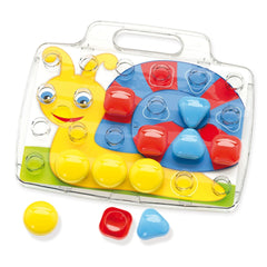 Quercetti FantaColor Baby features a yellow plastic base with red, blue, and green toys under a clear plastic lid.
