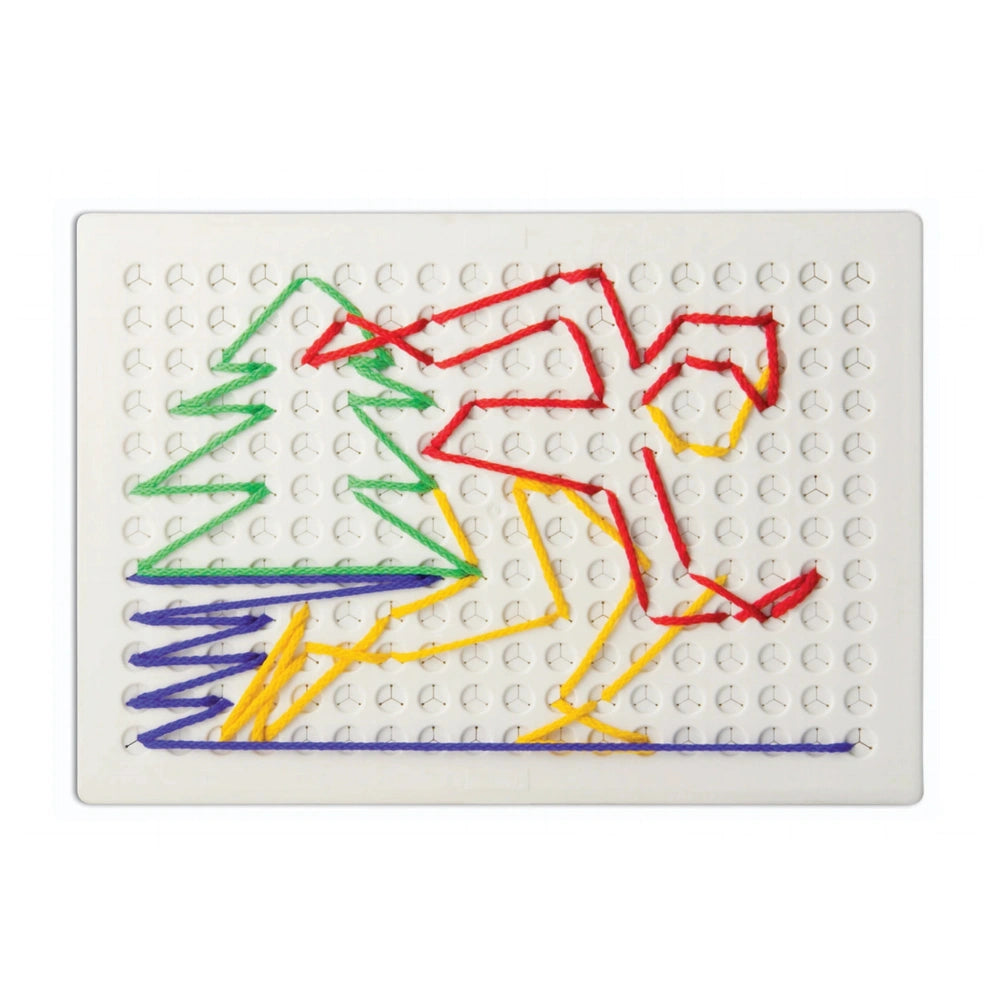 Quercetti Filo Filo arts and crafts featuring a colorful design with a person and a Christmas tree on a flat white surface.