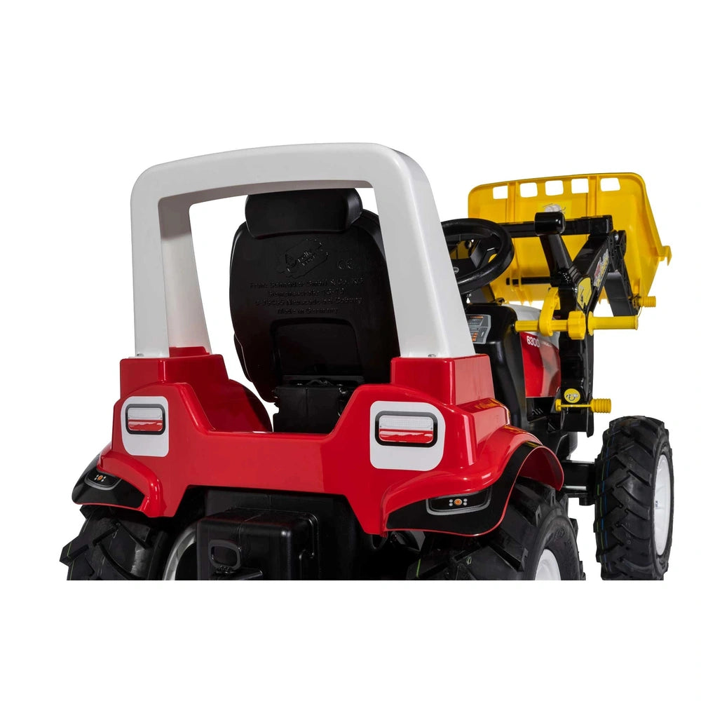 Rollyfarmtrac Premium II Steyr 6300 Terrus CVT toy four-wheeler in red and white with a black seat and large off-road wheels.