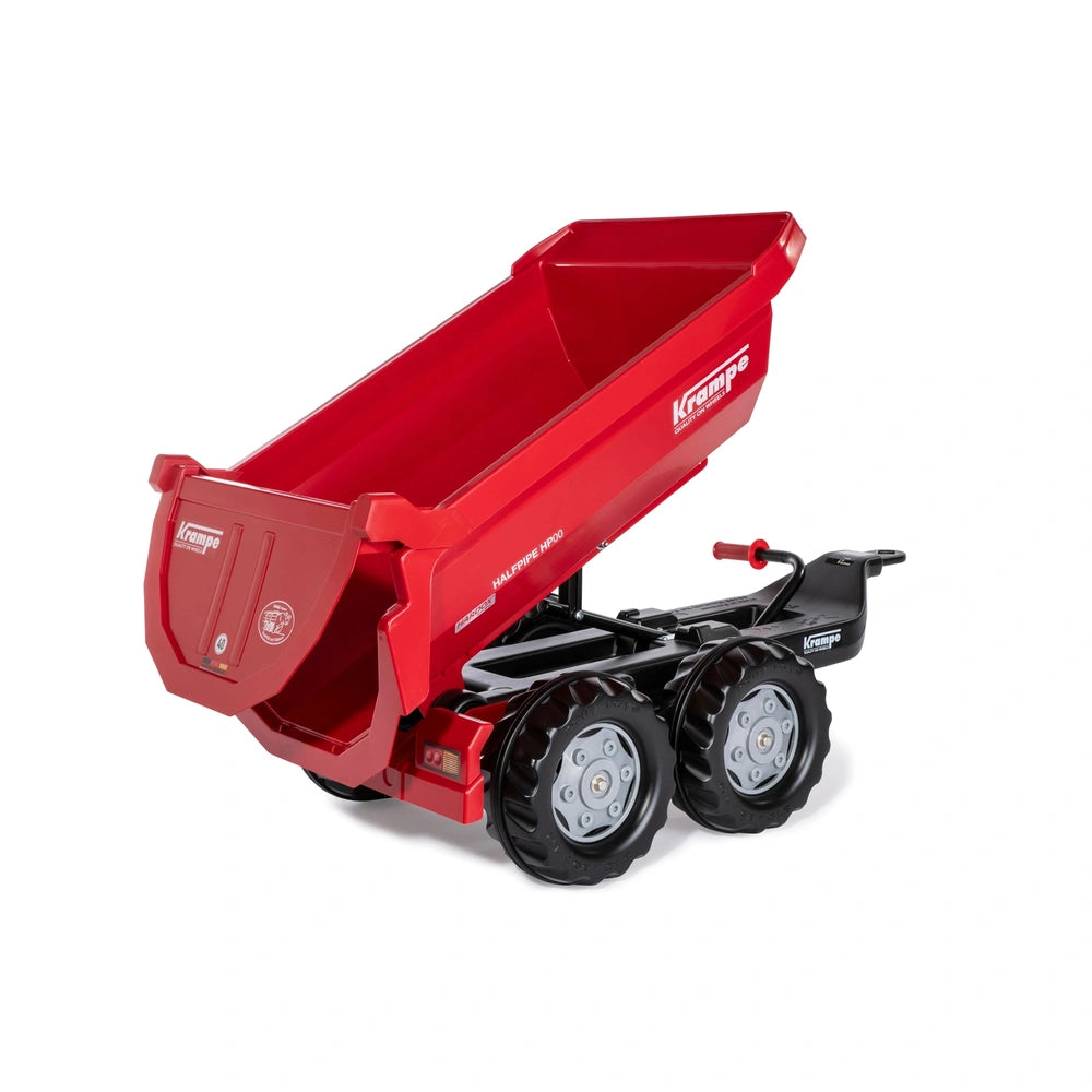 Rollyhalfpipe Krampe Trailer is a red plastic toy wheelbarrow with a black frame and wheels, set against a light background.
