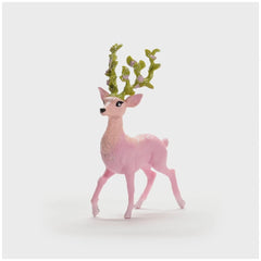 Magic deer figurine in pink with green antlers and mane, standing upright against a plain white background.