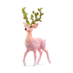 Magic deer figurine in pink with green antlers and wreath, featuring a shiny, plush texture against a light background.