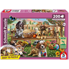 Schmidt Puzzle box showcases a colorful outdoor scene with playful dogs and cats, inviting children to enjoy a fun puzzle exp