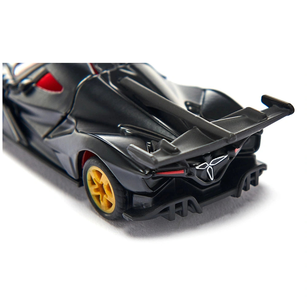Black toy sports car with a glossy finish, featuring a red and yellow wheel and a prominent rear wing.