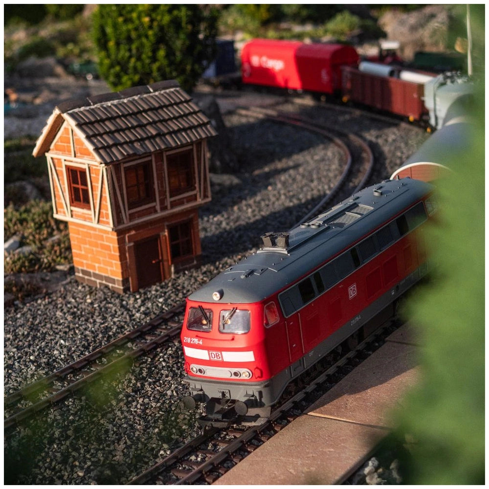 Teifoc's Big Timber-framed house model is set in a miniature landscape with a red and grey model train on metal tracks.